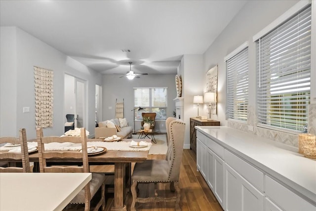 dining room featuring ceiling fan and dark wood-type flooring