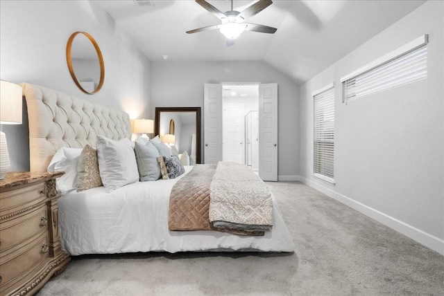 carpeted bedroom with vaulted ceiling and ceiling fan