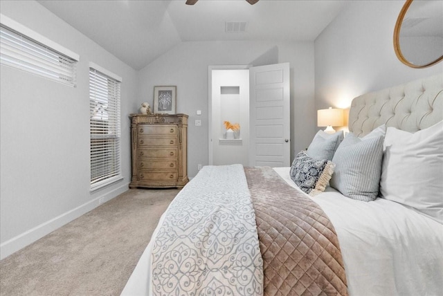 bedroom with ceiling fan, lofted ceiling, and light carpet