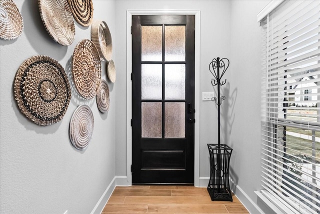 entrance foyer featuring a healthy amount of sunlight and light wood-type flooring