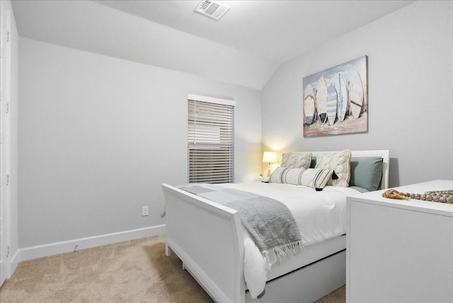 carpeted bedroom featuring lofted ceiling