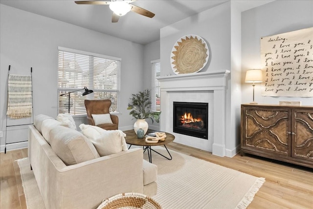 living room featuring ceiling fan and light hardwood / wood-style flooring