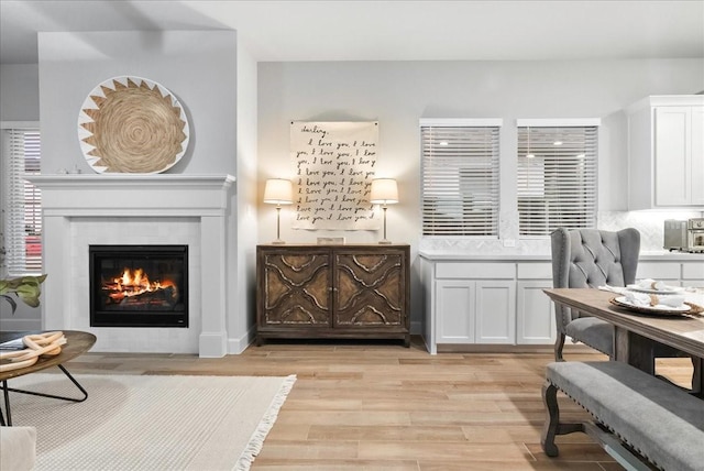 sitting room featuring a fireplace and light wood-type flooring