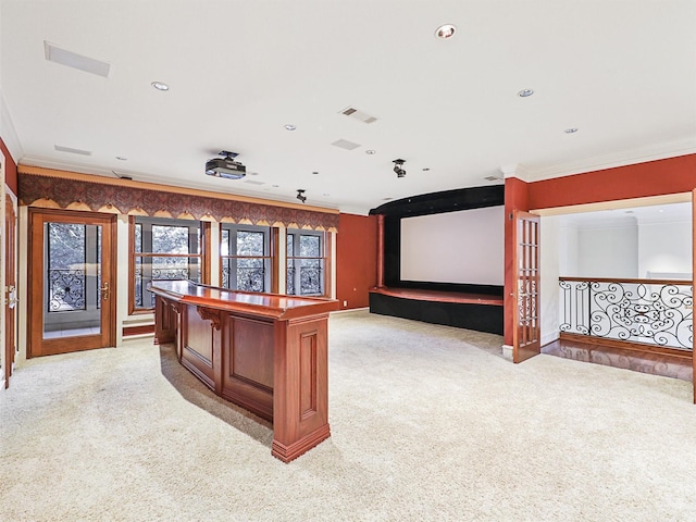 carpeted cinema room featuring crown molding