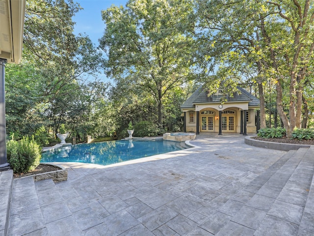 view of swimming pool featuring french doors, an in ground hot tub, an outdoor structure, and a patio