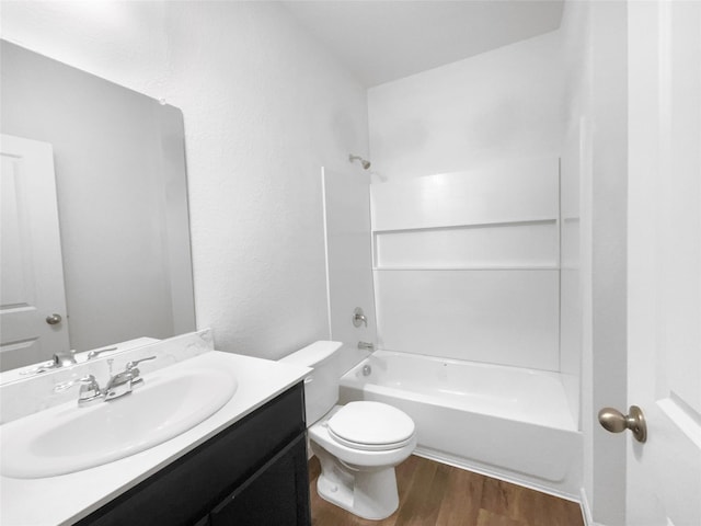 full bathroom with shower / tub combination, vanity, toilet, and hardwood / wood-style floors