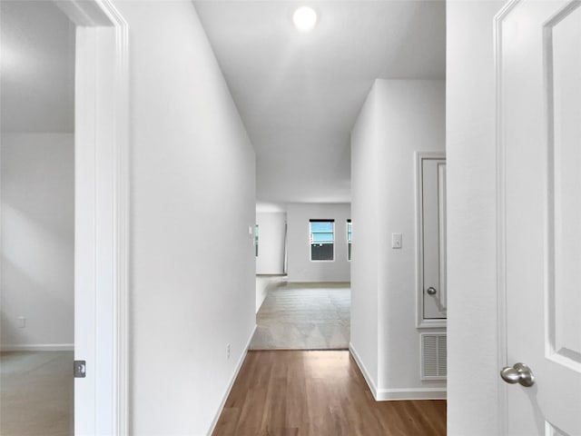 hallway with dark hardwood / wood-style flooring