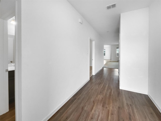 corridor featuring dark wood-type flooring