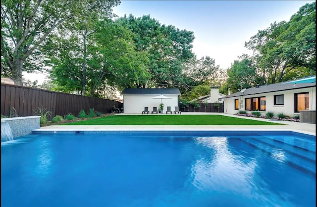 view of pool with a yard, an outdoor structure, and central air condition unit