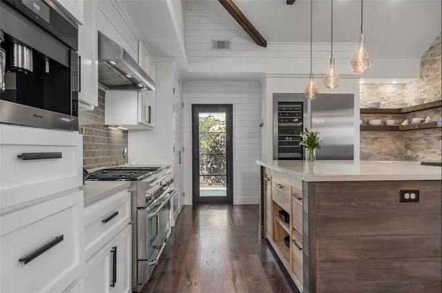 kitchen with white cabinets, ventilation hood, stainless steel appliances, and dark hardwood / wood-style floors