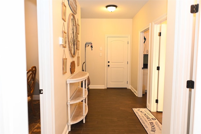 corridor with dark hardwood / wood-style flooring