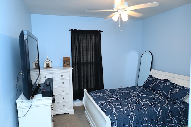 bedroom with ceiling fan and dark carpet