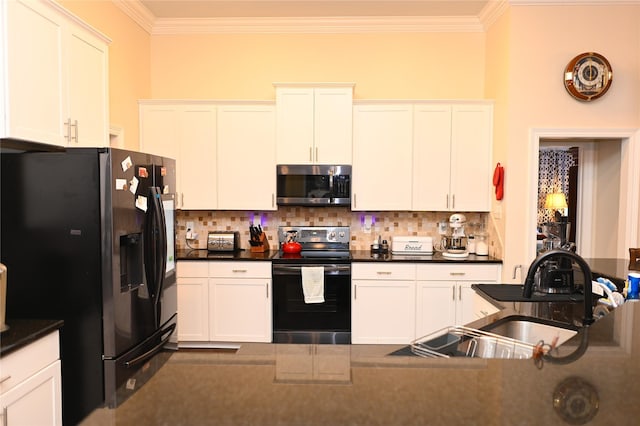 kitchen featuring tasteful backsplash, appliances with stainless steel finishes, and white cabinets