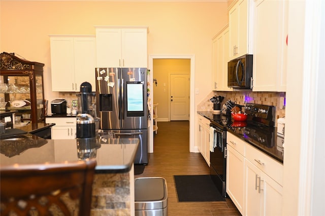 kitchen featuring stainless steel fridge with ice dispenser, black / electric stove, dark hardwood / wood-style flooring, white cabinets, and backsplash