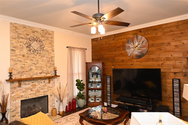 living room featuring ornamental molding, ceiling fan, and a fireplace