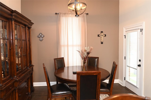 dining area with an inviting chandelier and dark hardwood / wood-style flooring