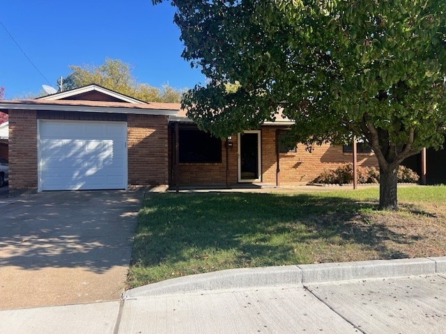 single story home featuring a garage and a front lawn