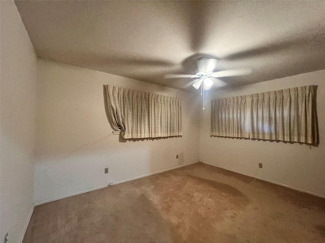 carpeted empty room with a textured ceiling and ceiling fan