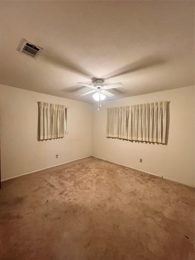 spare room with ceiling fan and carpet floors