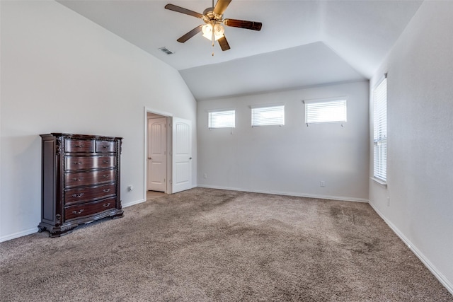 interior space featuring a wealth of natural light, ceiling fan, and lofted ceiling