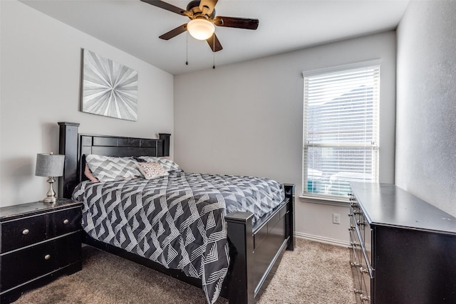 carpeted bedroom with multiple windows and ceiling fan