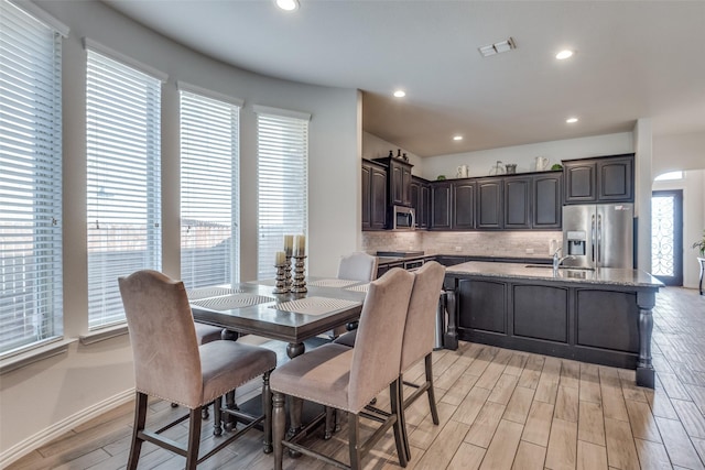 dining space with a wealth of natural light and light hardwood / wood-style flooring