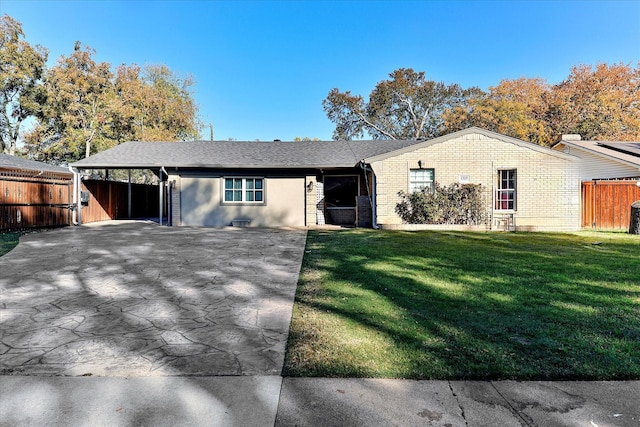 ranch-style house featuring a front yard and a carport