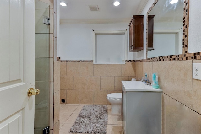 bathroom featuring tile patterned flooring, vanity, and tile walls