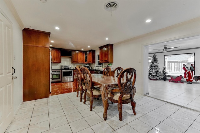 dining room with light tile patterned floors, ceiling fan, and crown molding