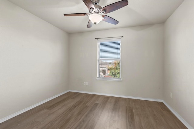 empty room with ceiling fan and hardwood / wood-style flooring