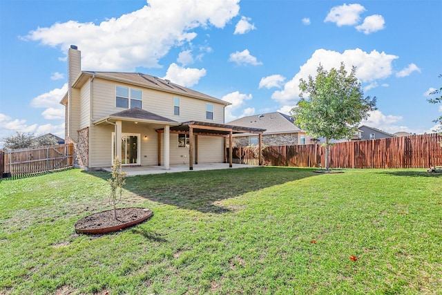 back of property with a yard and a patio area