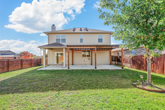 back of property with a yard and a patio area