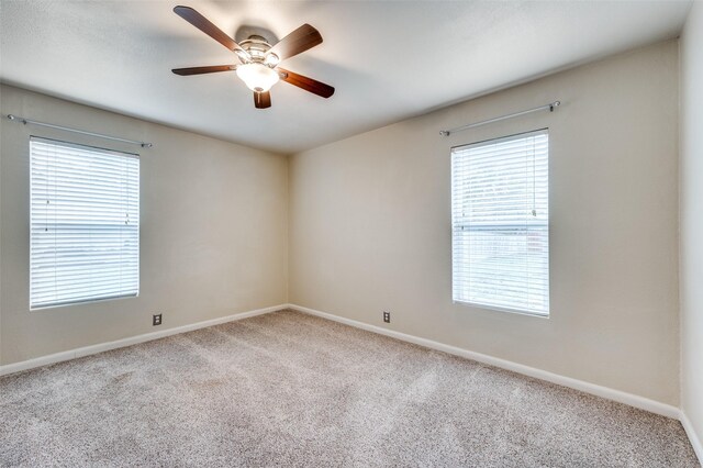 unfurnished room with carpet flooring and plenty of natural light