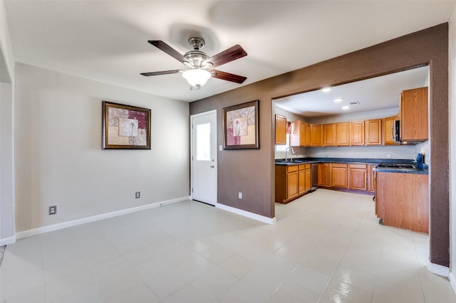 kitchen featuring light tile patterned floors, stainless steel dishwasher, ceiling fan, and sink