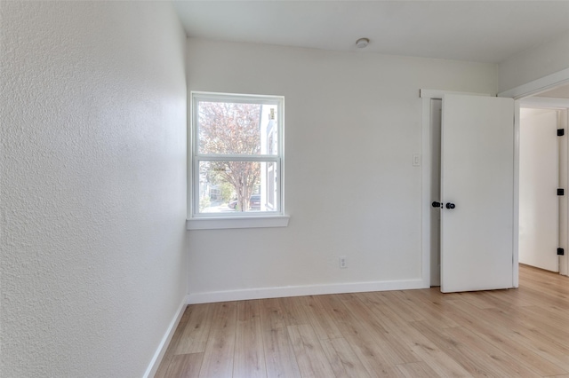 unfurnished room with light hardwood / wood-style flooring