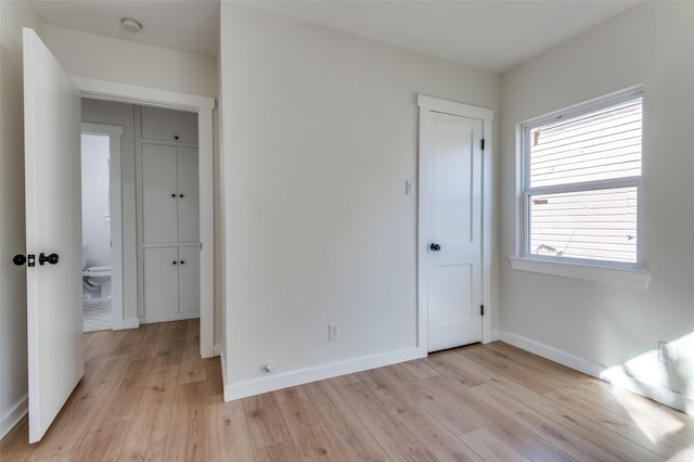 unfurnished bedroom with light wood-type flooring