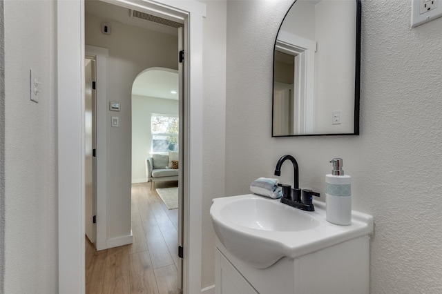 bathroom with hardwood / wood-style floors and vanity