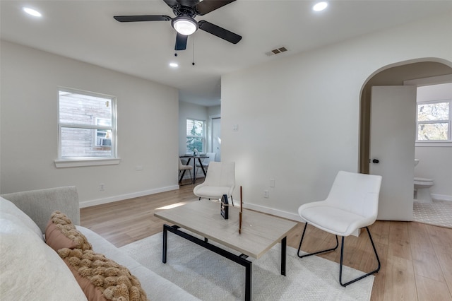 living area featuring light wood-type flooring and ceiling fan