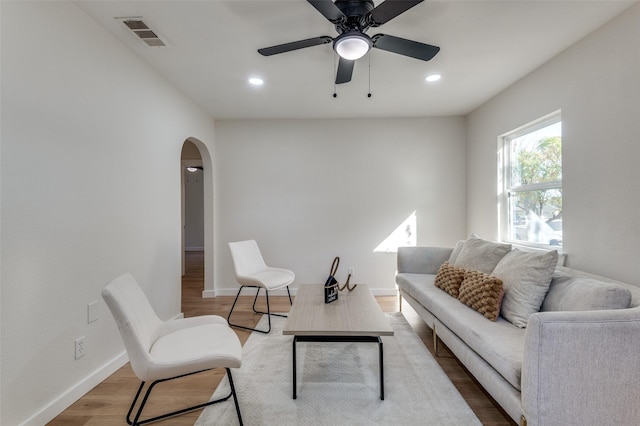 living room featuring ceiling fan and wood-type flooring