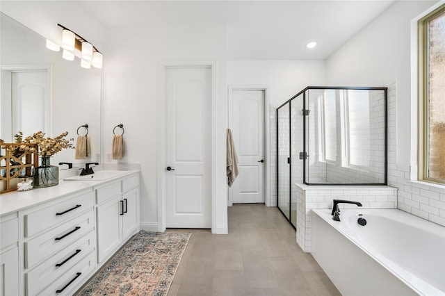 bathroom featuring vanity, recessed lighting, a stall shower, tile patterned flooring, and a garden tub