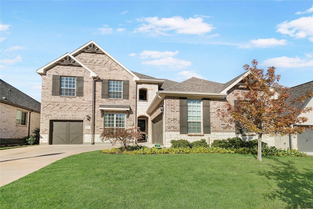 view of front of house with roof with shingles, concrete driveway, a front lawn, a garage, and brick siding