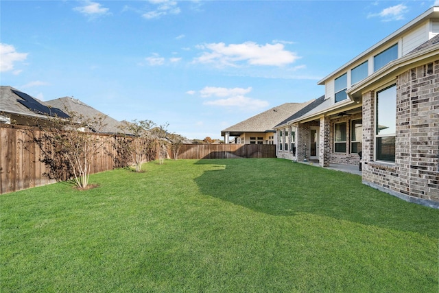 view of yard with a patio area and a fenced backyard