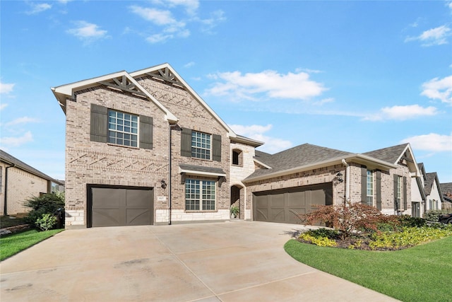 view of front of home with brick siding, driveway, and roof with shingles