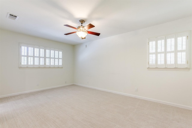 carpeted empty room featuring ceiling fan