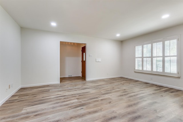 spare room featuring light hardwood / wood-style flooring