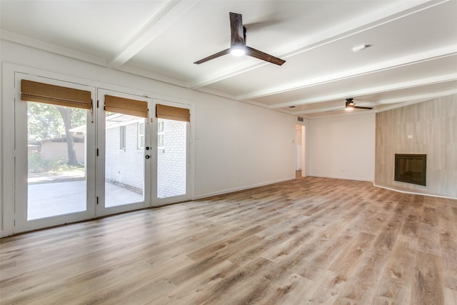 unfurnished living room featuring beamed ceiling, ceiling fan, light hardwood / wood-style floors, and a large fireplace