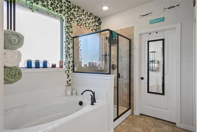 bathroom with independent shower and bath and tile patterned flooring