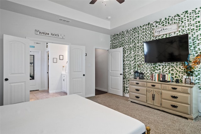 tiled bedroom with ceiling fan and connected bathroom