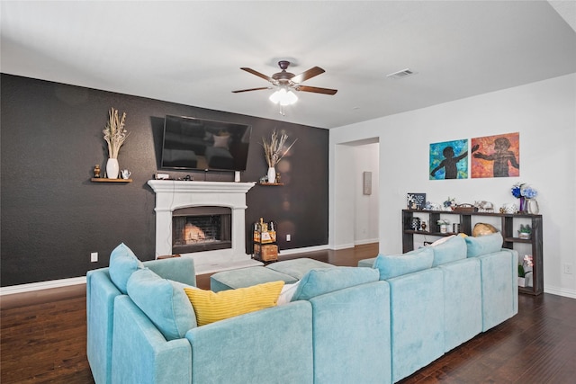 living room featuring dark hardwood / wood-style floors and ceiling fan