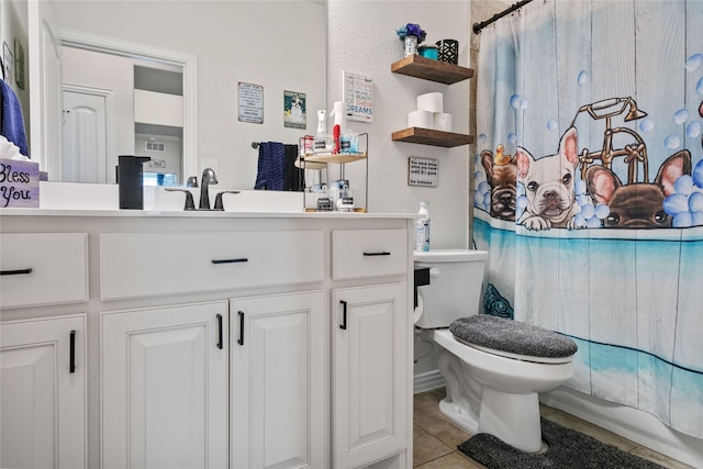 bathroom with vanity, toilet, and tile patterned flooring